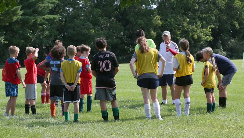 Gordan Raketic, former professional player in Slovenia, Austria, and Spain, talks to a group of kids during the Astra Soccer Academy free soccer clinic on Thursday, July 25, 2024 at Jefferson School in Princeton. Raketic welcomes any children in the Princeton area to participate in the free camp.