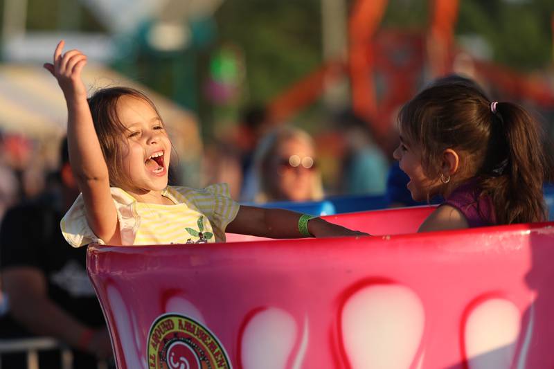 Alayna Rodriguez, 6 years old, and her friend Roxy Campos enjoy the tea cup ride at Lockport’s Canal Days on Friday, June 9, 2023.