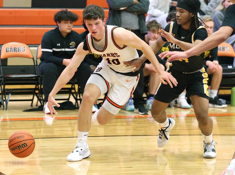 DeKalb’s Eric Rosenow goes baseline against Metea Valley's James Parker during their game Friday, Jan. 19, 2024, at DeKalb High School.