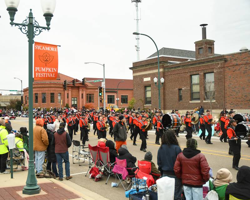 The DeKalb High School marching band marches down Main Street in downtown Sycamore during the Pumpkin Parade to conclude the 62nd annual Sycamore Pumpkin Festival on Sunday, Oct. 29, 2023.