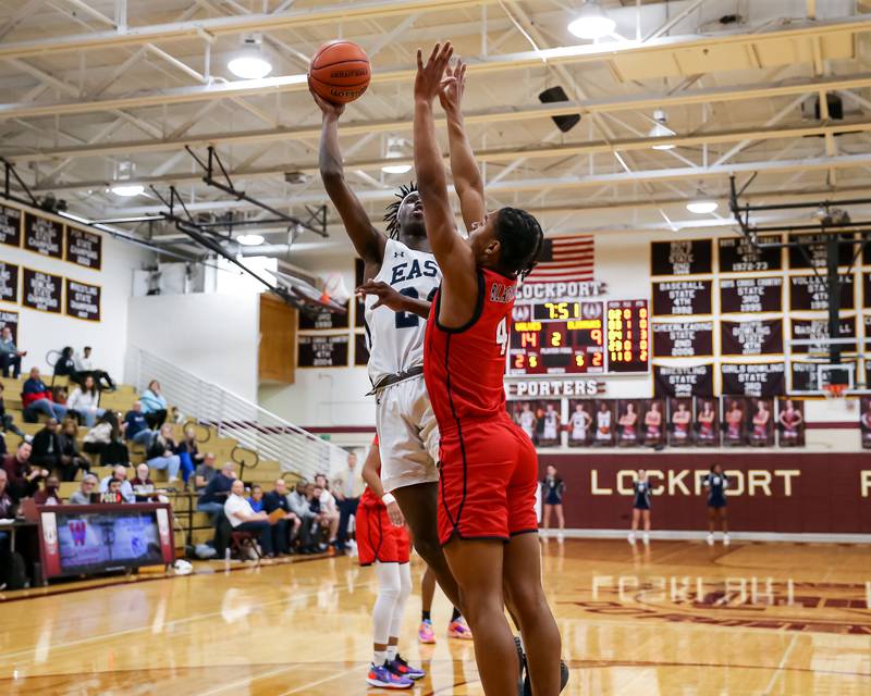 Oswego East's Mekhi Lowery (24) puts up a shot during Class 4A Lockport Regional final game between West Aurora at Oswego East.  Feb 24, 2023.