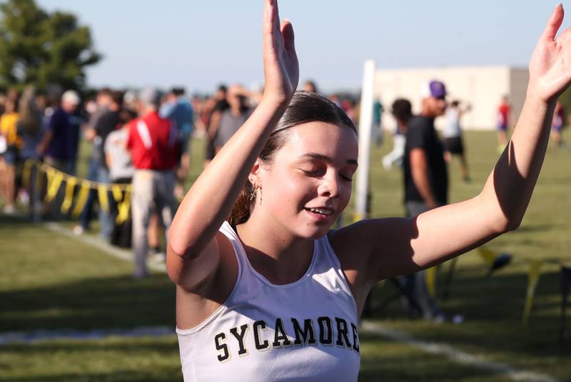 Sycamore’s Layla Janisch is happy with her time as she finishes the girls varsity race Tuesday, Sept. 3, 2024, at the Sycamore Cross Country Invite at Kishwaukee College in Malta.