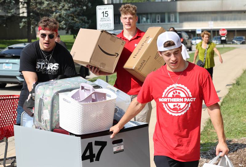 Northern Illinois University student volunteers help new arrivals get their things moved into their rooms Wednesday, Aug. 23, 2023, during move-in day in front of the Fanny Ruth Patterson Complex at NIU in DeKalb.