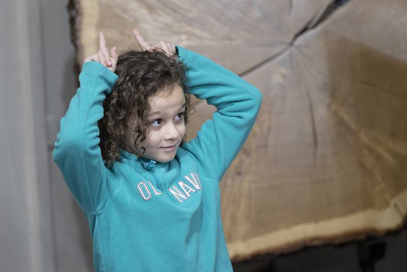 Looking to mimic the stellar hearing of the fox, Kennedy Hallstrom, 6, of Sterling displays her own fox ears. Master gardener and naturalist Nancy Wadsworth then had the young students cup their hands behind their ears to hear the difference ear shape makes.