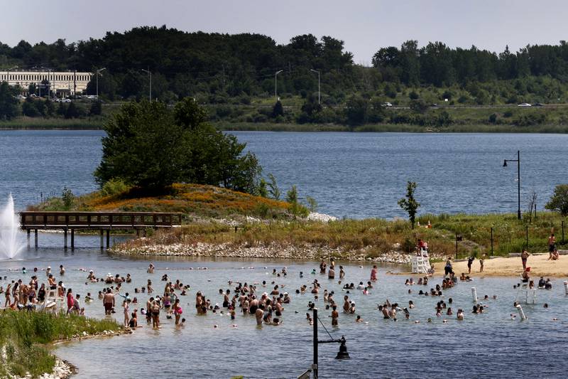 People cool off on Wednesday, June 19, 2024, in the swimming area of Three Oaks Recreation Area.