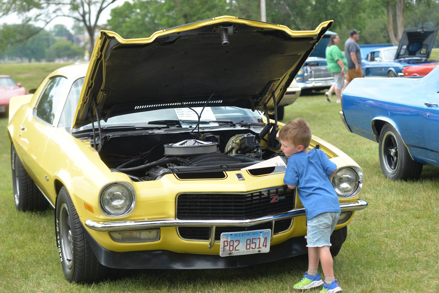 Waylon Coutts, 3, of Sterling looks at Roger Pederson's 1970 Camaro at the Oregon Lions Club's Father Day's Car Show on Sunday, June 16, 2024. The Oregon car was one of 128 vehicles entered into this year's show.