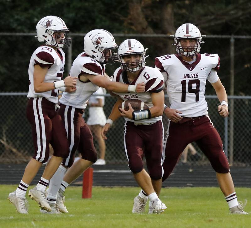 Prairie Ridge's Luke Vanderwiel celebrates a touchdown with his teammates during a Fox Valley Conference football game against Jacobs on Friday, Aug 30, 2024, at Jacobs High School in Algonquin.