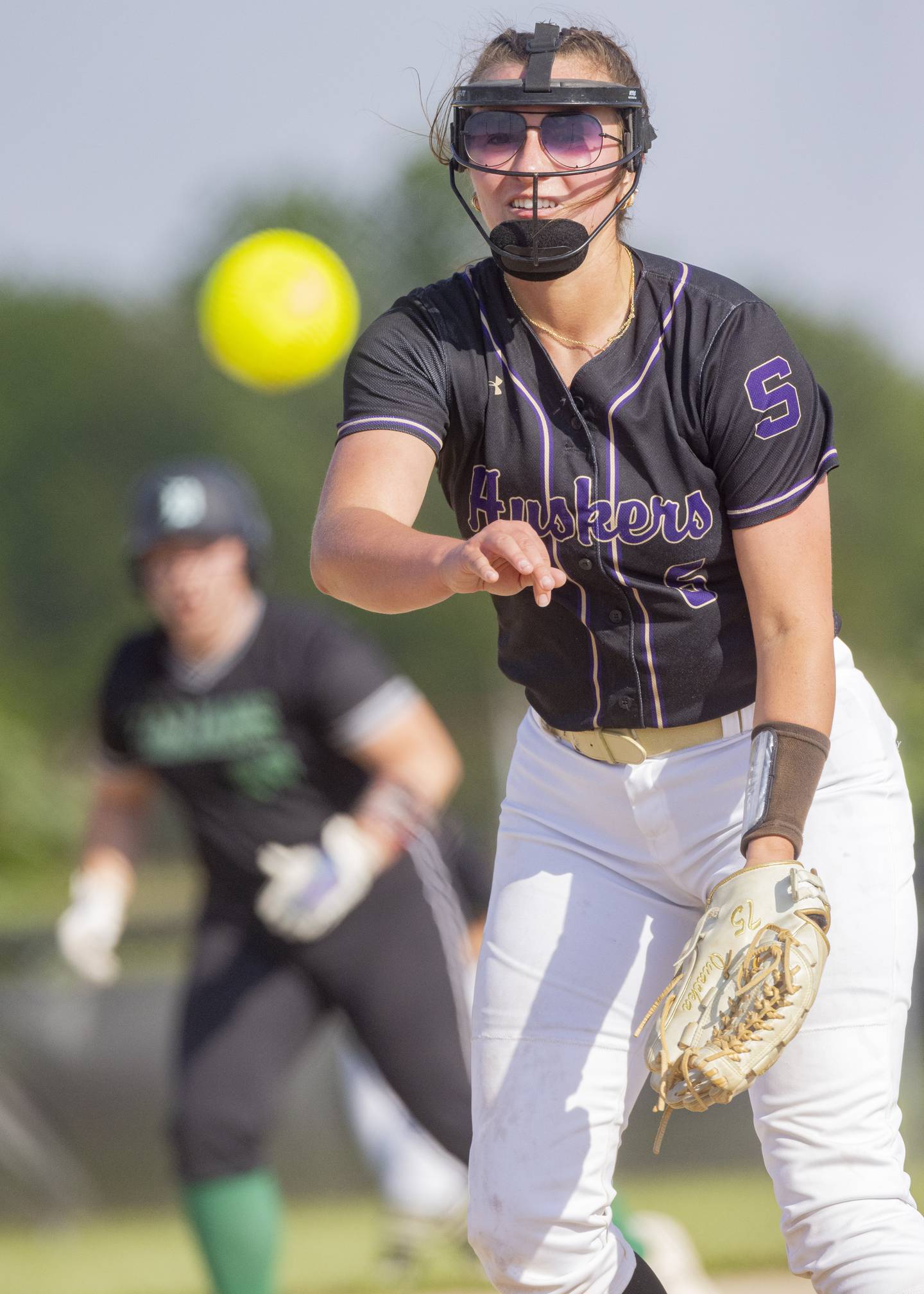 Serena's Maddie Glade throws a pitch with a Dwight High School player in scoring position during the Class 1A sectional semifinal at Woodland School on May 21, 2024.