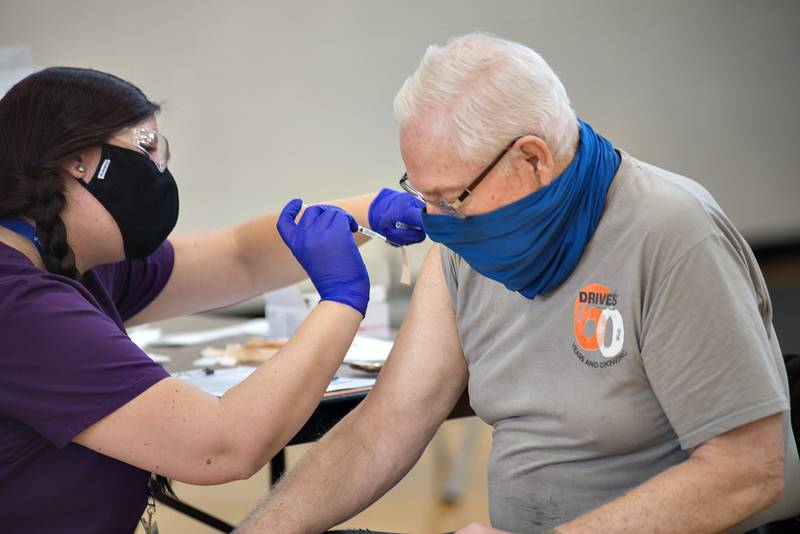 Richard Tanton of Sterling gets his COVID-19 shot from Whiteside County Health Department nurse Amanda Lasson Wednesday morning in Fulton.