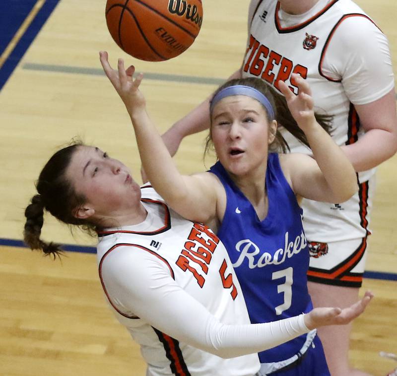 Burlington Central's Savannah Scheuer tries to grab a rebound against Crystal Lake Central's Addison Cleary during the IHSA Class 3A Woodstock Regional Championship girls basketball game on Thursday, Feb. 15, 2024, at Woodstock High School.