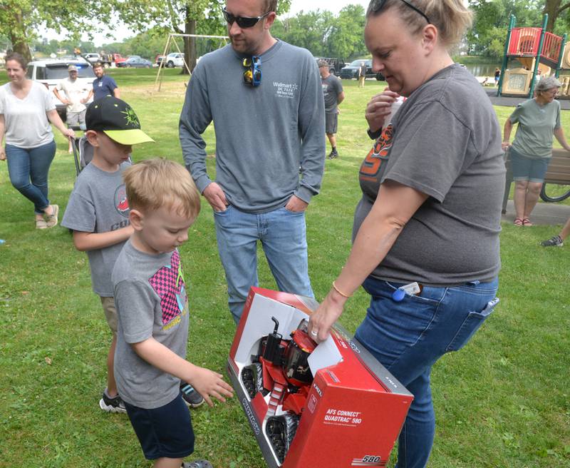 Karter Moffitt,, 7,, of Prophetstown, checks out the toy tractor his brother, Kolten, won at the 18th annual Dick Brown Fishing Derby at Prophetstown State Park on Saturday, June 15, 2024. Pictured with Kolten and Karter are thei parents, Jessica and Ron.