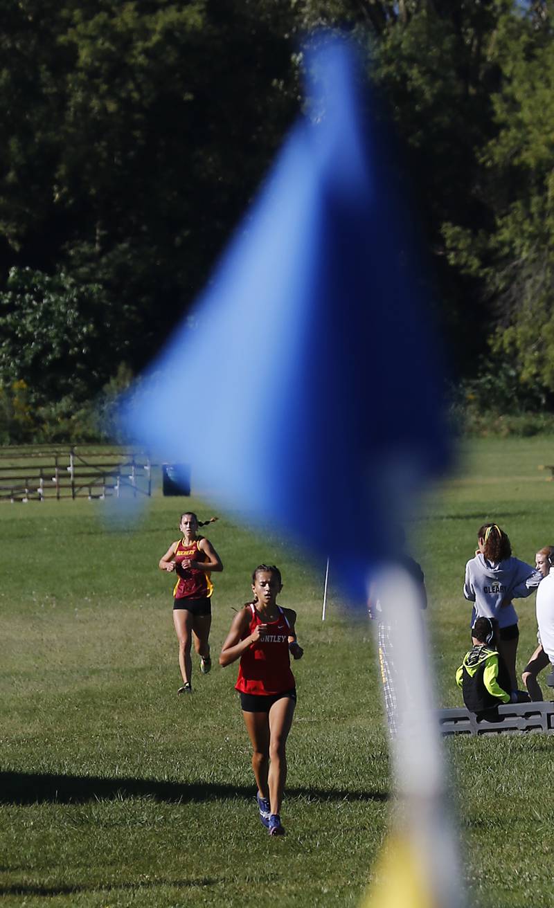 Huntley’s Haley Rahman pulls away from Richmond-Burton’s Alexia Spatz as they compete in the girls race of the McHenry County Cross Country Invite on Saturday, August 31, 2024, at McHenry Township Park in Johnsburg.