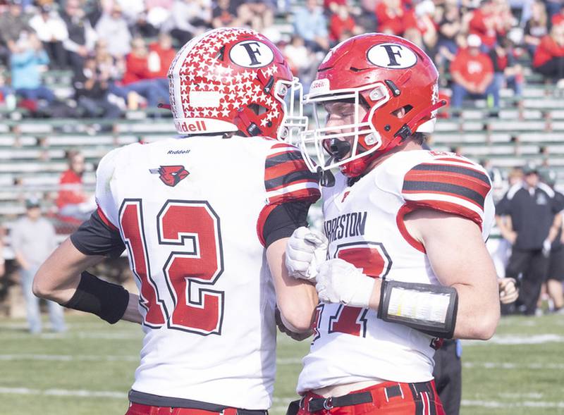 Forreston's quarterback Brock Smith celebrates with teammate Kyler Ganz after scoring a touchdown against St. Bede during the Class 1A first round playoff game on Saturday, Oct. 29, 2022 at the Academy in Peru.