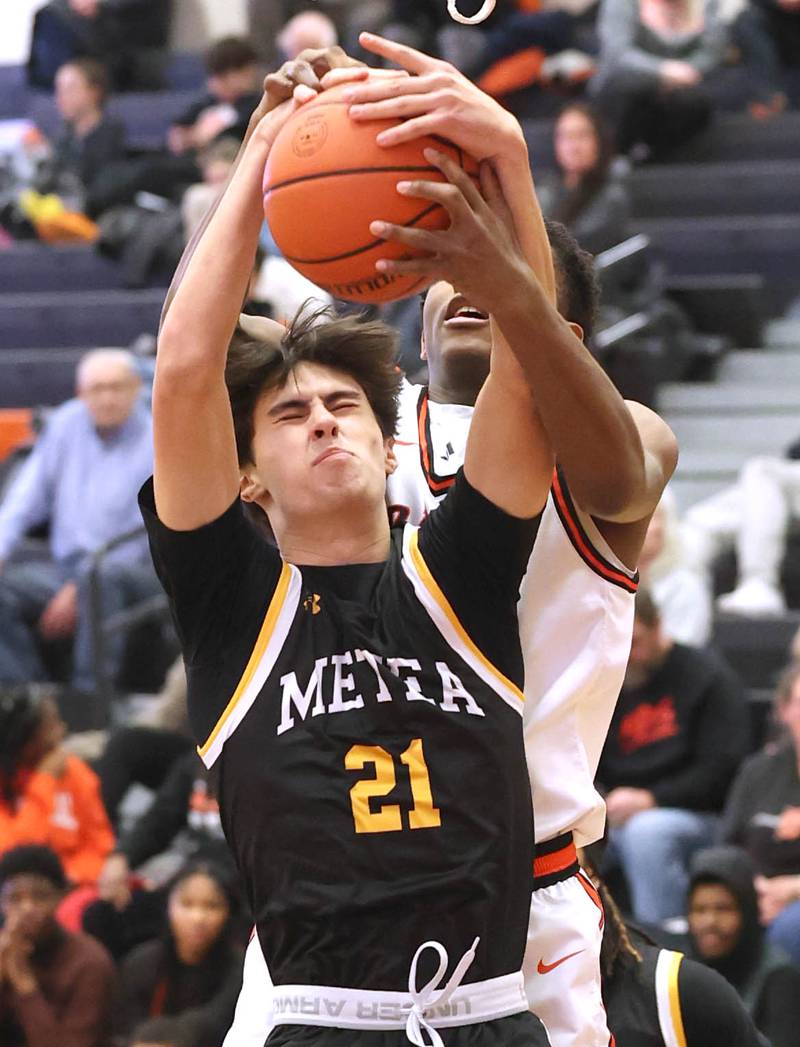 DeKalb’s Justin O’Neal and Metea Valley's Kyle Bucher go after a rebound during their game Friday, Jan. 19, 2024, at DeKalb High School.