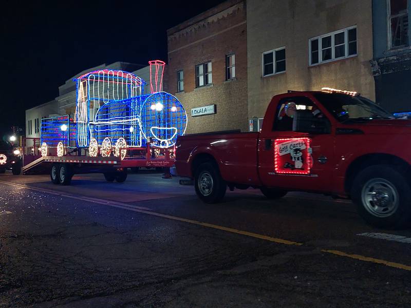 An illuminated train makes its way Saturday, Dec. 2, 2023, along the Lighted Christmas Parade route in Peru.