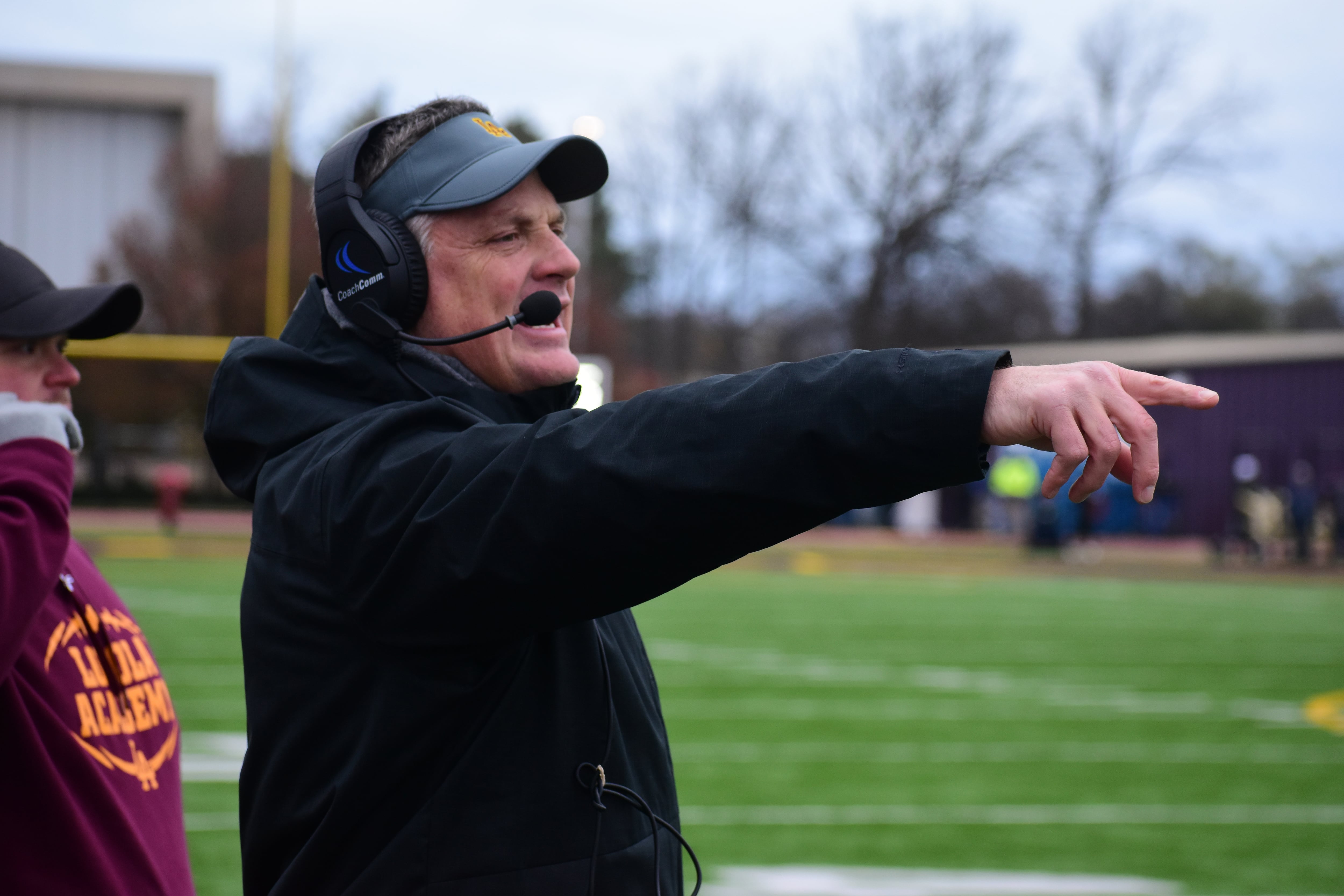 Loyola coach John Holecek points something out to his team during a game in 2022. The Ramblers coach announced his retirement on Monday.