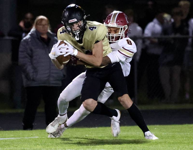 Sycamore's Aidan Wyzard makes a catch in front of Morris' Caleb Walton during their game Friday, Oct. 18, 2024, at Sycamore High School.