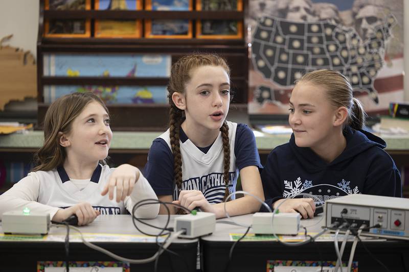 Dixon St. Mary’s 5th graders Stella Murphy (left), Hadleigh Shippert and Blake Foster answer questions during a Catholic Schools Week Scholastic Bowl showdown Thursday, Feb. 1, 2024 at the school.