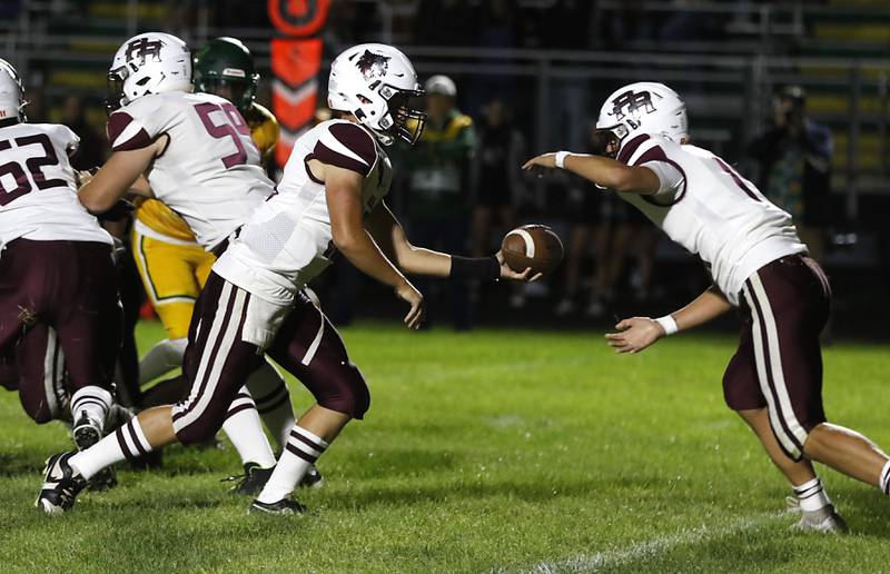 Prairie Ridge's Owen Satterlee hands the ball off to running back Jake Wagler during a Fox Valley Conference football game against Crystal Lake South on Friday, Sept. 6, 2024, at Crystal Lake South High School.