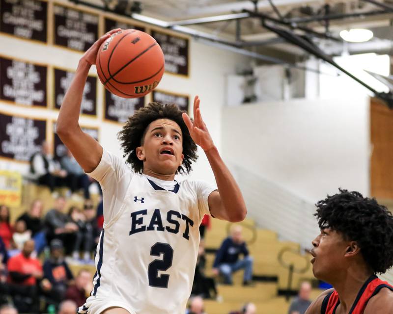 Oswego East's Bryce Shoto (2) drives in for a lay up during Class 4A Lockport Regional final game between West Aurora at Oswego East.  Feb 24, 2023.