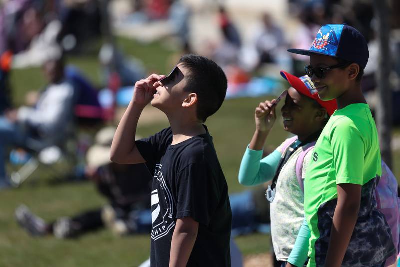 A few children watch the eclipse at the Joliet Junior College solar eclipse viewing event on Monday, April 8, 2024 in Joliet.