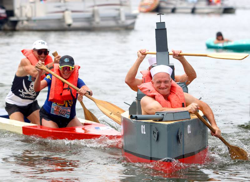 Brian Korreck, right, paddles his battleship-themed craft with teammate Sean Donahue during the Cardboard Regatta on Crystal Lake Saturday. Both are from Crystal Lake.