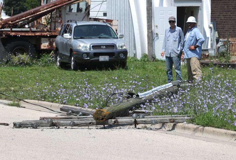 A power pole blown over by Sunday night’s storm lies across West Page Street Monday, July 15, 2024, in Sycamore. High Winds and heavy storms hit DeKalb County overnight causing downed trees and power outages in the area.