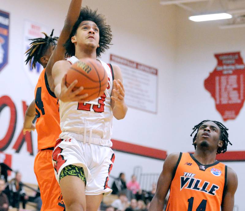 Yorkville's Jory Boley (23) scores with an underhand layup against Romeoville defender Adam Walker during a varsity basketball game at Yorkville High School on Friday, Jan. 19, 2024.