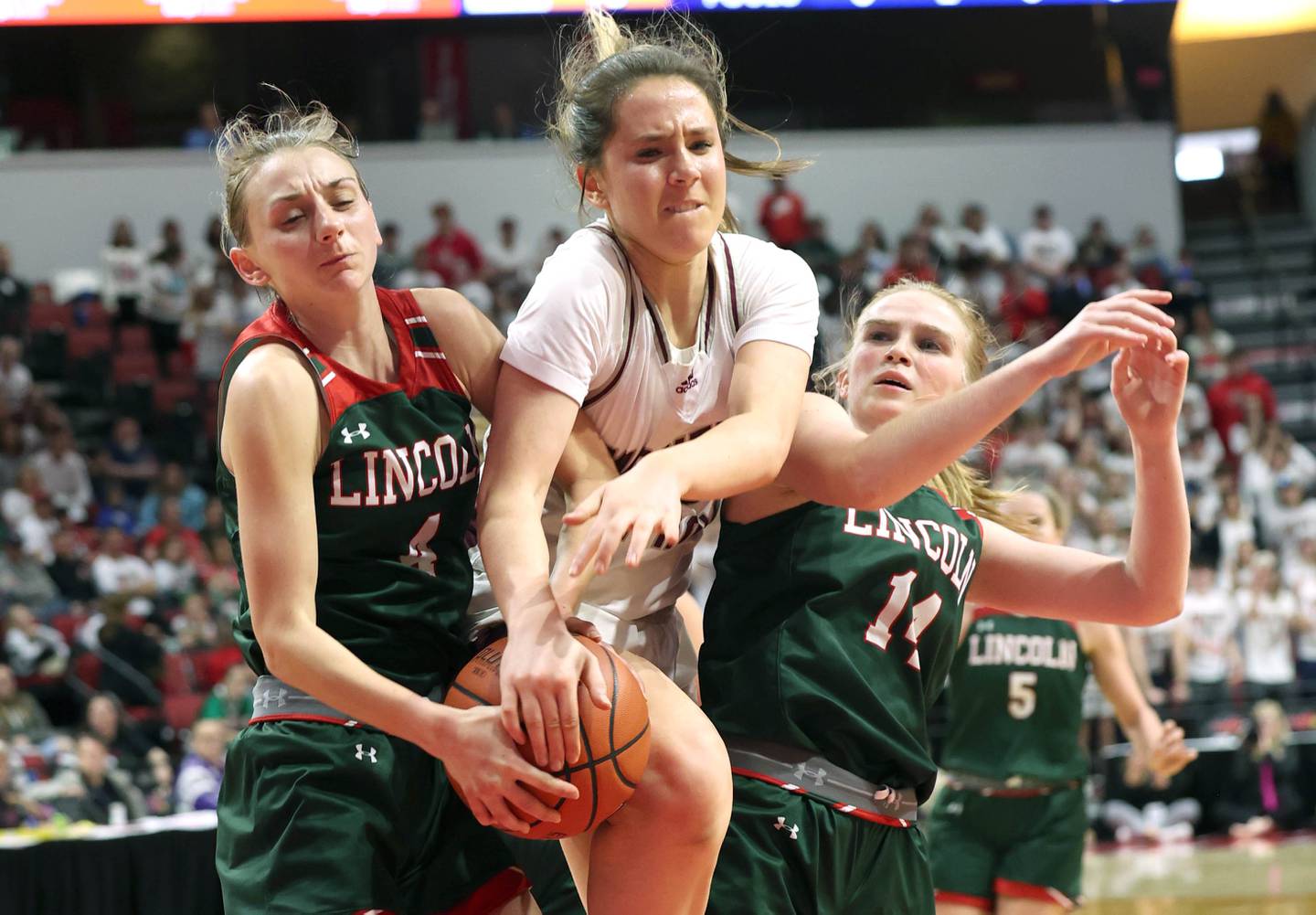 Montini's Peyton Farrell goes after a rebound between Lincoln's Becca Heitzig (left) and Jenna Bowman during their game Friday, March 1, 2024, in the IHSA Class 3A state semifinal at the CEFCU Arena at Illinois State University in Normal.