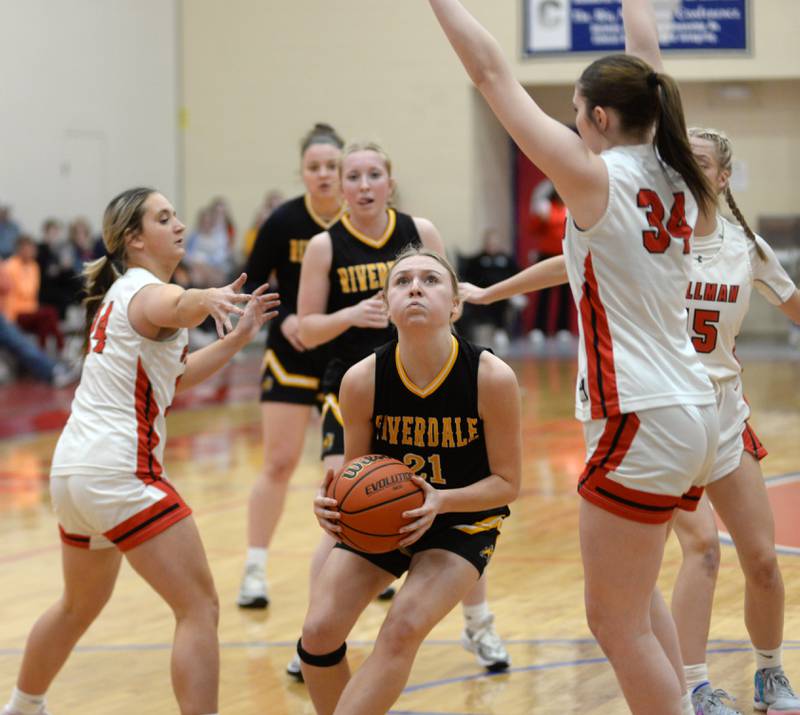 Riverdale's Cayleigh Hungate (21) splits two  Stillman Valley defenders during a Tuesday. Feb. 20, 2024 game at the 2A Oregon Sectional held at the Blackhawk Center at Oregon High School. The Rams fell 57-34 to the Cardinals.