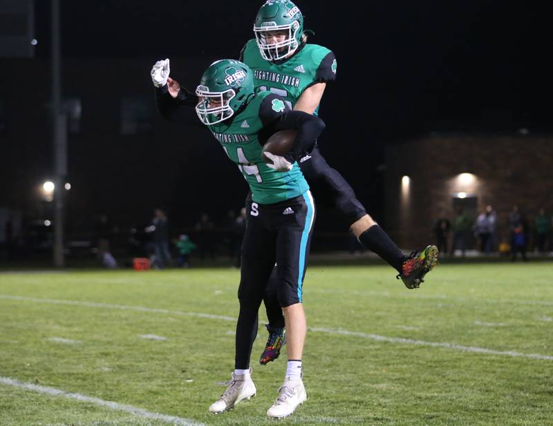 Seneca's Kevin Einhaus reacts with teammate Paxton Giertz after intercepting a pass against Marquette on Friday, Oct. 18, 2024 at Seneca High School.