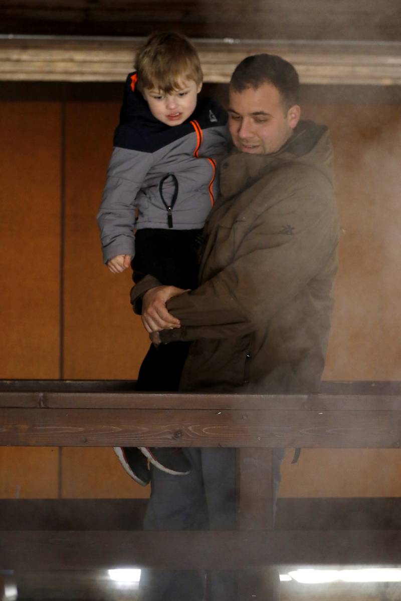 Dan Ayala and his sone, Ben, 3, of Lake in the Hills, looks as maple sap is cooked down to maple syrup during the McHenry County Conservation District’s annual Festival of the Sugar Maples, at Coral Woods Conservation Area, in Marengo, on Monday, March 11, 2024.