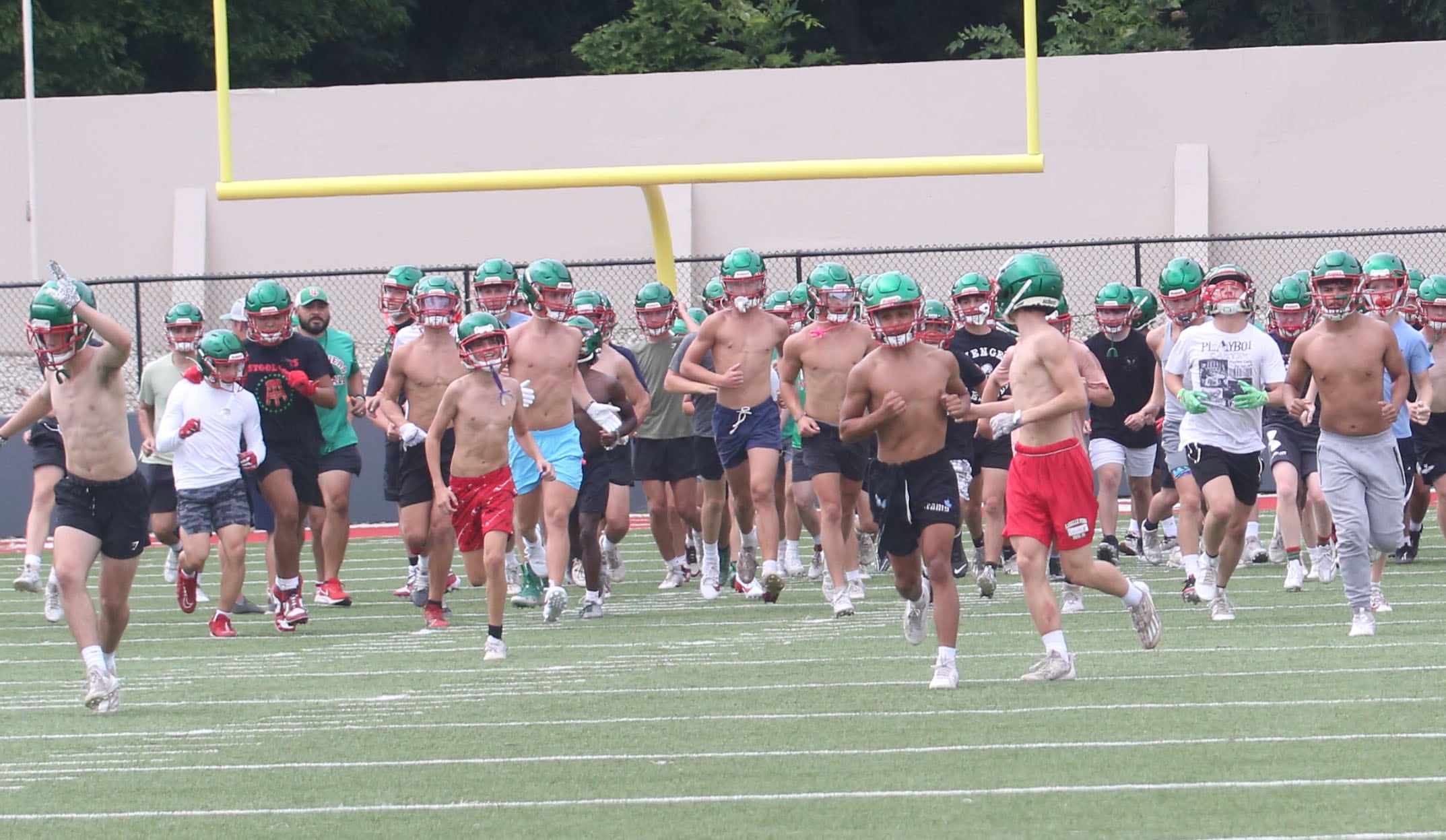 Members of the L-P Cavalier football team run onto Howard Fellows Stadium for the first day of practice on Monday, Aug. 12, 2024.