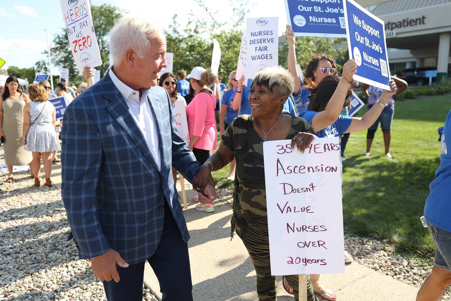 Joliet Mayor Terry D’Arcy shares his support with Pat Need, a nurse for 35 years, during a picket outside St. Joseph Hospital as nurses contract negotiations continue on Thursday, July 20th, 2023 in Joliet.