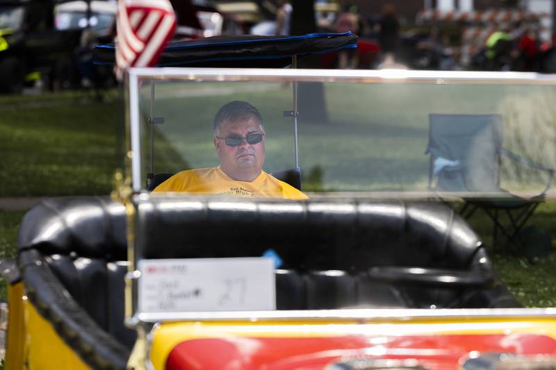 Ron Bychowski of Genoa sits with his 1924 hot rod Ford Monday, July 3, 2023 at Petunia Fest’s car show. Bychowski is a big fan of car shows and seeing the smiles on the kids who climb into the front seat of the cool car.