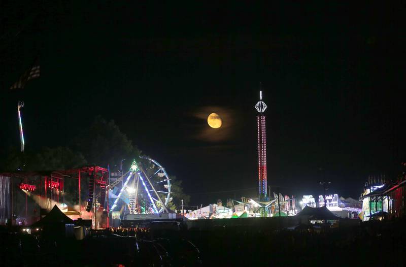 A nearly full moon rises during the 169th Bureau County Fair on Thursday, Aug. 22, 2024 in Princeton.