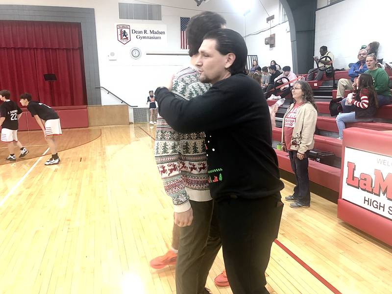 LaMoille coach Chance Blumhorst hugs his brother, DePue coach Trae Blumhorst, before Friday's game in LaMoille.