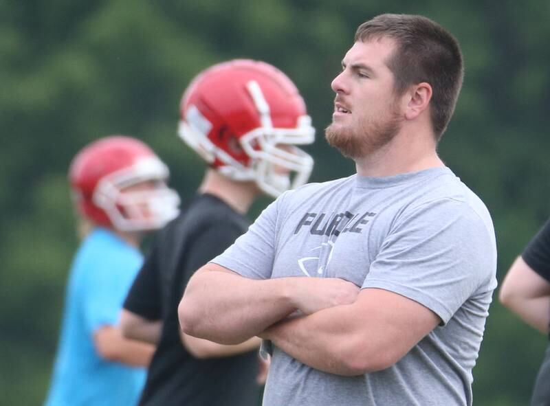 Hall football coach Logan Larson coaches his team during practice on Tuesday, July 9, 2024 at Hall High School. Larson grew up in Springfield and played his first two years of high school at Sacred Heart-Griffin before playing his final two years at Pleasant Plains. He played his freshman year of college at Bowling Green State University. then transferred to SEMO after a coaching change. After college, he coached at Springfield Southeast for three years and spent the last three years at Athens. Larson was the offensive and defensive line coach and special teams coordinator for Athens.