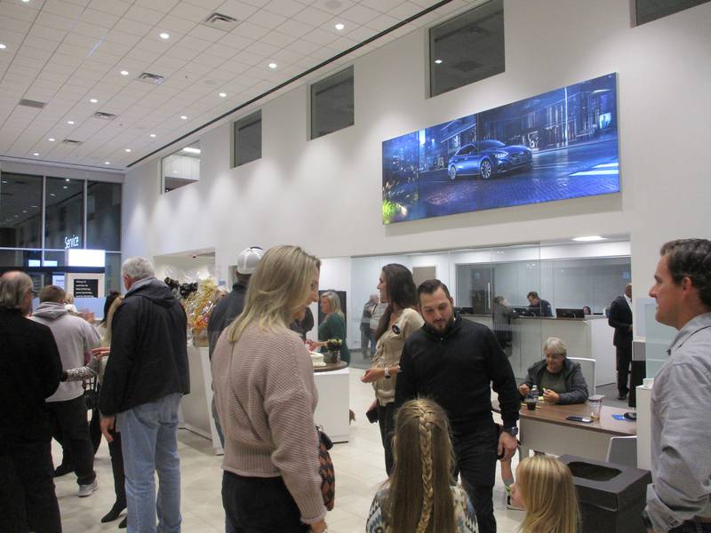 People gather in the showroom of the new D'Arcy Hyundai dealership in Joliet ahead of a ribbon-cutting ceremony on Thursday, Nov. 9, 2023.