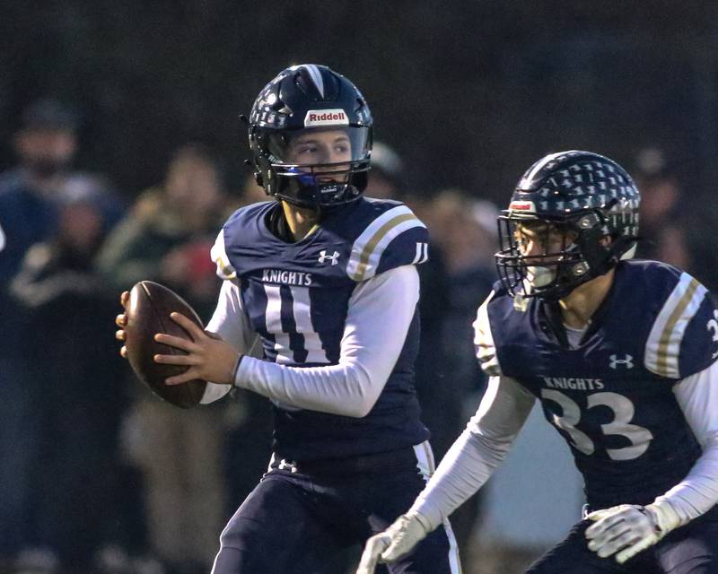 IC Catholic Prep's Dennis Mandala (11) looks to pass during Class 4A third round playoff football game between St Laurence at IC Catholic Prep.  Nov 11, 2023.