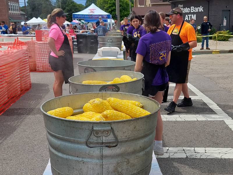 Steaming sweet corn sits in buckets waiting to be distributed Sunday, Aug. 13, 2023, during the Mendota Sweet Corn Festival.