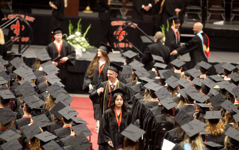 St. Charles East graduates walk back to their seats after getting their diplomas during the school’s 2024 commencement ceremony at Northern Illinois University in DeKalb on Monday, May 20, 2024.