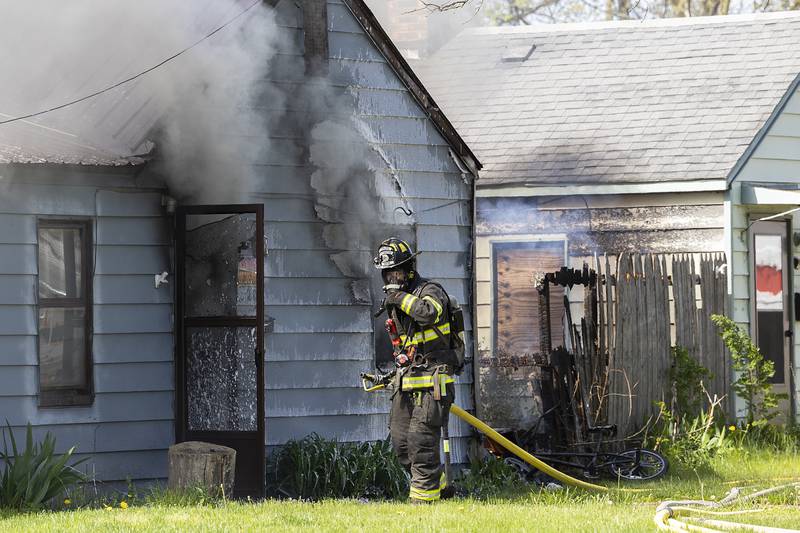 Firefighters work at the scene of a house fire at 204 East 11th Street in Rock Falls Wednesday, May 1, 2024. Neighbors heard an explosion prior to the house fire on the State Fire Marshal is investigating.