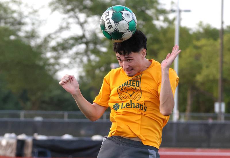 DeKalb County United’s Julian Garcia, from DeKalb, heads the ball Thursday, June 6, 2024, during practice at the Northern Illinois University Soccer and Track and Field Complex in DeKalb.