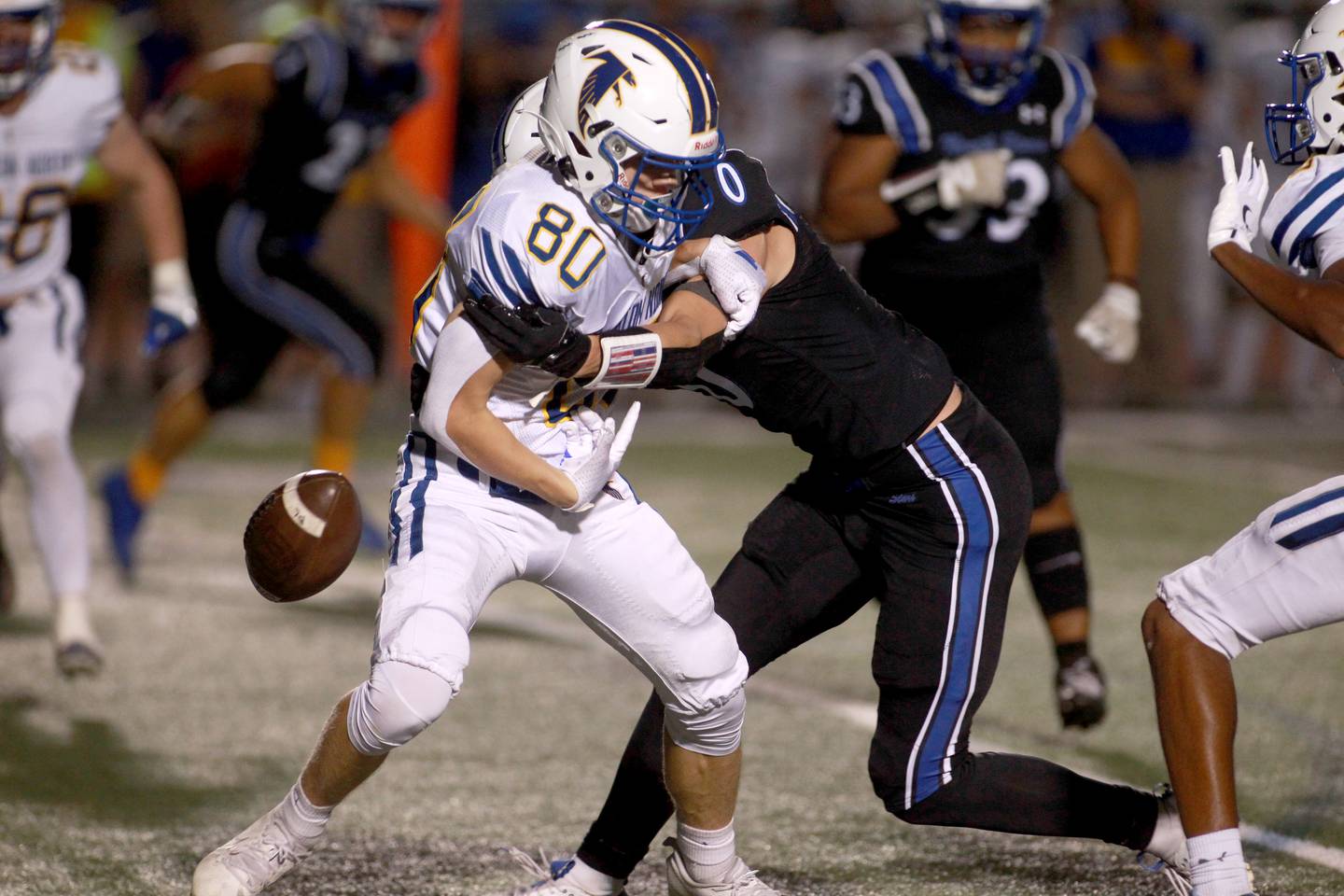 Wheaton North’ David Hyde (left) is stripped of the ball by St. Charles North’s Aidan McClure during a game Friday, Sept. 13, 2024 at St. Charles North.