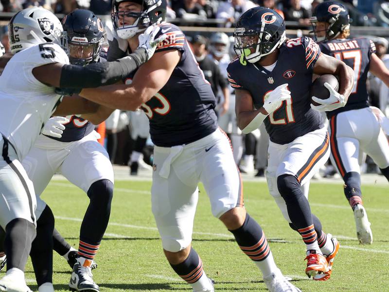 Chicago Bears running back D'Onta Foreman carries the ball as Chicago Bears tight end Cole Kmet makes a block on Las Vegas Raiders linebacker Divine Deablo during their game Sunday, Oct. 22, 2023, at Soldier Field in Chicago.