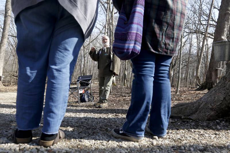 Volunteer Ken Williams teaches visitors how to identify sugar maple trees during the McHenry County Conservation District’s annual Festival of the Sugar Maples, at Coral Woods Conservation Area, 7400 Somerset Drive in Marengo.