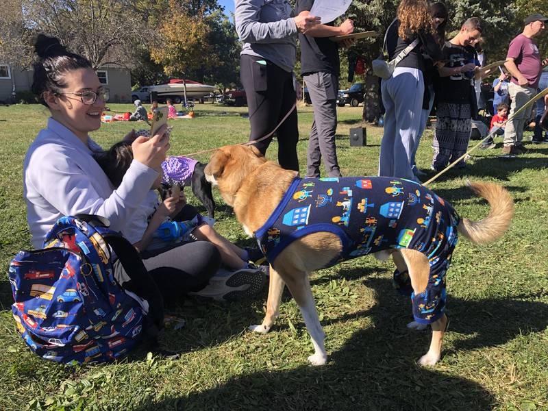 Brittany Eisenberg and her son, Zane, 3, of Deerfield greet a dog in a dog fashion show at Furever Home Dog Sanctuary near Spring Grove Oct. 19, 2024.