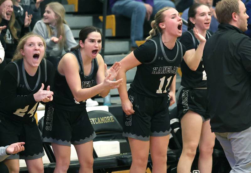 The Kaneland bench celebrates a big basket during their Class 3A sectional semifinal against Sycamore Tuesday, Feb. 20, 2024, at Sycamore High School.