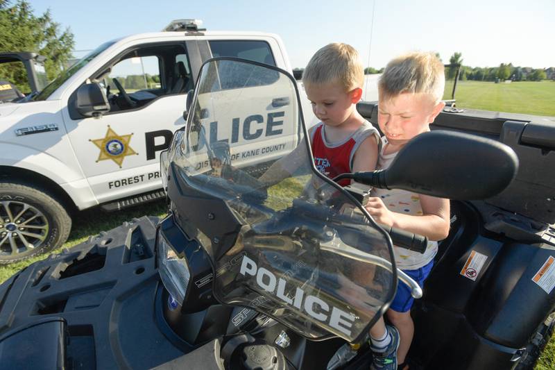 Teddy Markin, 4 and Ben Zavler, 5 check out a police ATV during the Campton Hills National Night Out event on Tuesday, August 2, 2022.